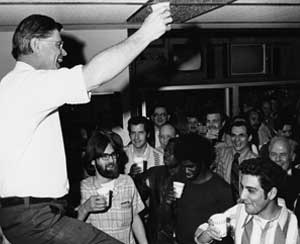 Robert R. Wilson (left), director of the National Accelerator Laboratory, Batavia, Ill., offers a toast to fellow employees when the accelerator reached its design energy of 200 GeV, 1 March 1972.